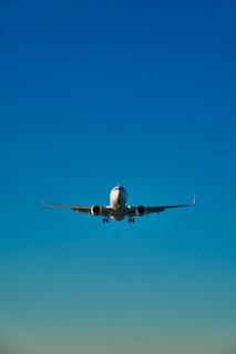 a large jetliner flying through a blue sky