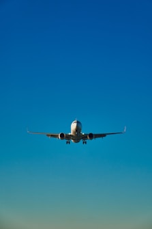 a large jetliner flying through a blue sky