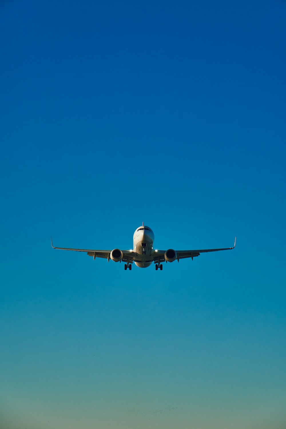 a large jetliner flying through a blue sky