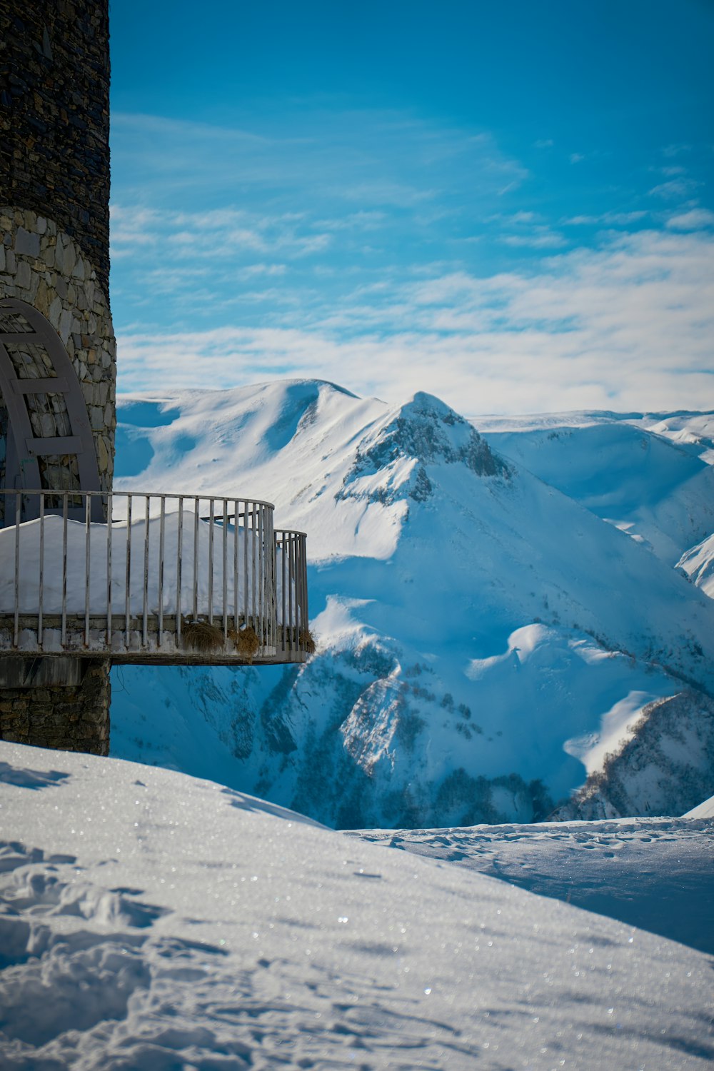 a view of a snowy mountain range from a building