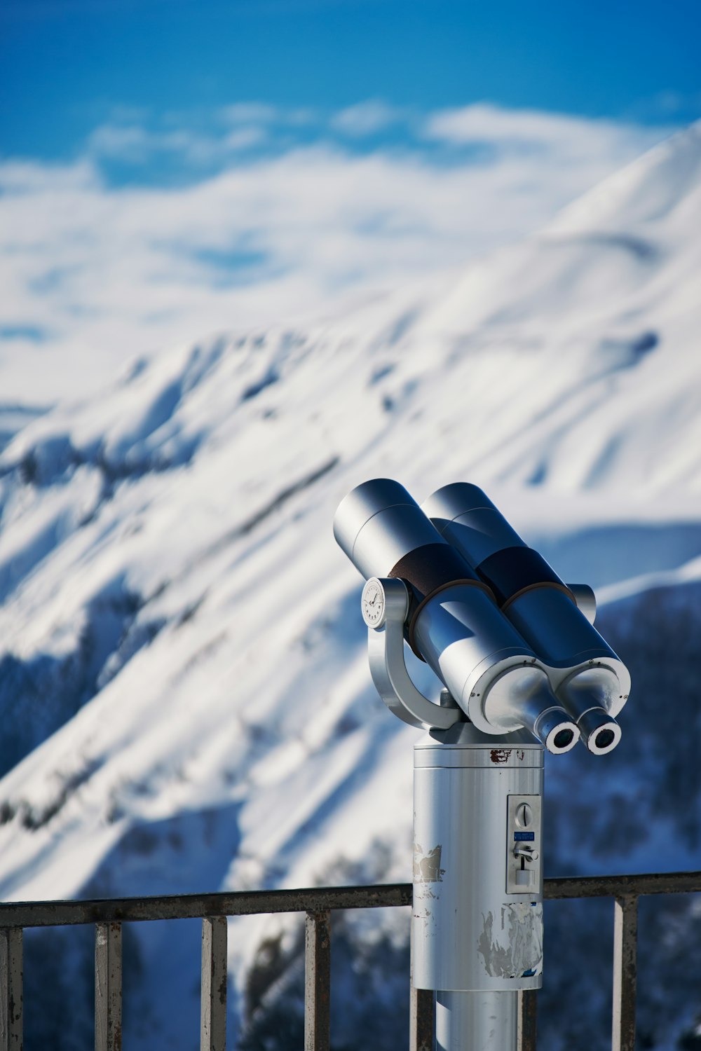 a telescope sitting on top of a metal pole