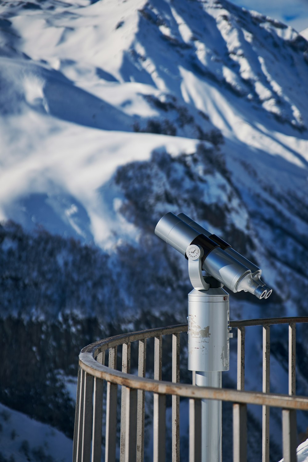 a telescope sitting on top of a metal fence