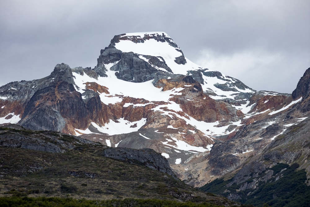 a large mountain covered in snow on a cloudy day