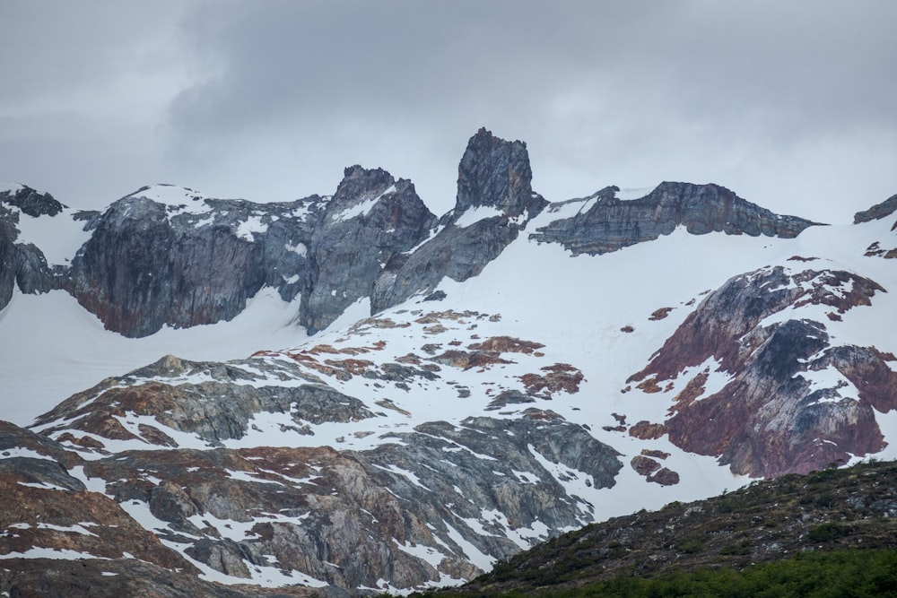 a mountain range covered in snow and rocks