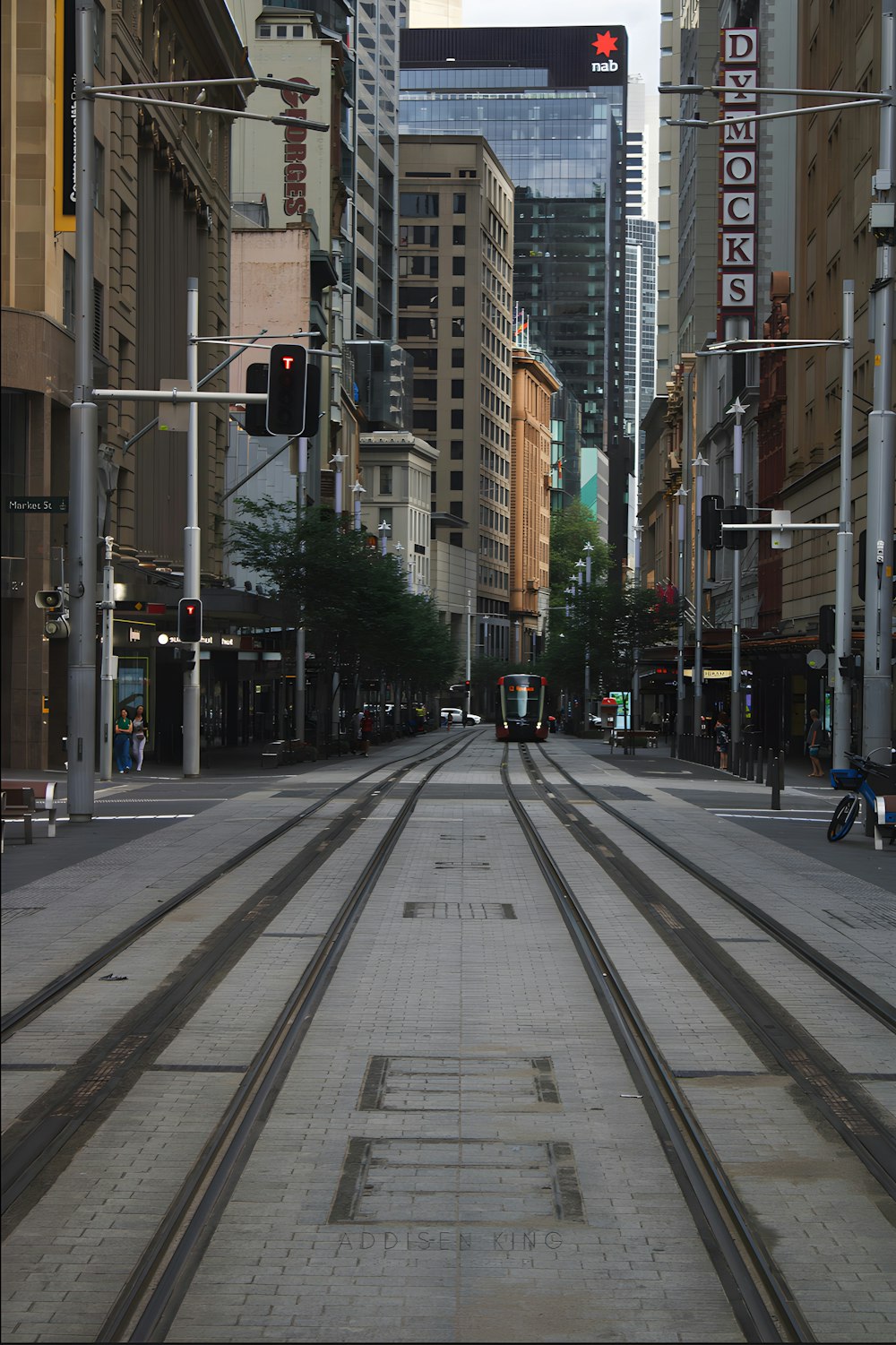 a train track running through a city with tall buildings