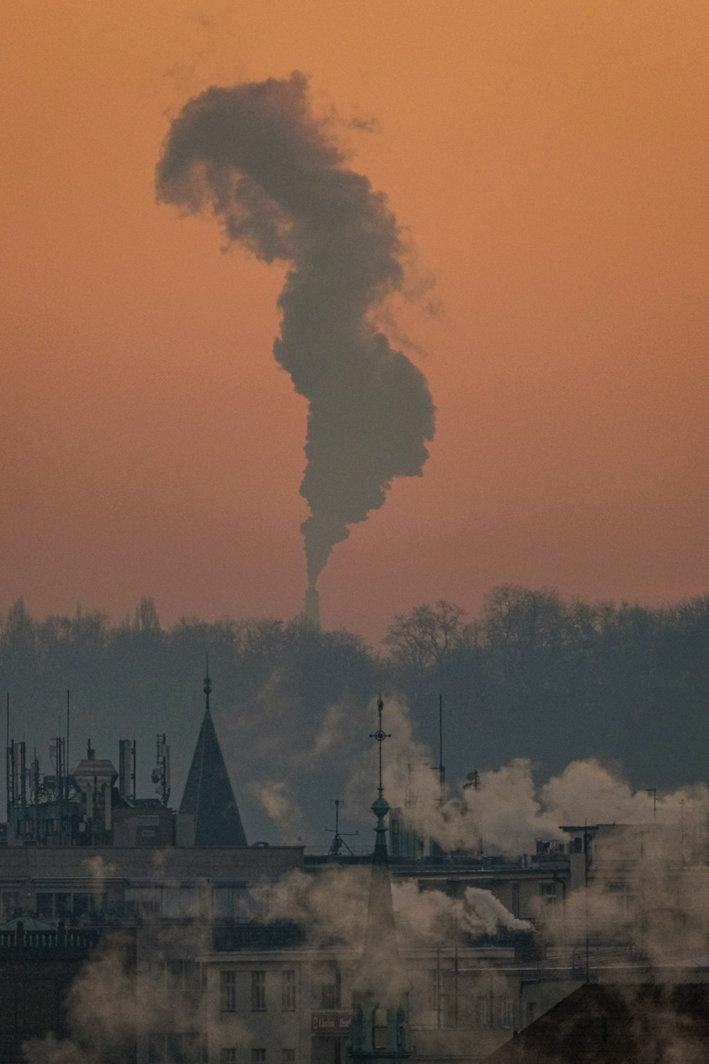 smoke billows from the top of a building