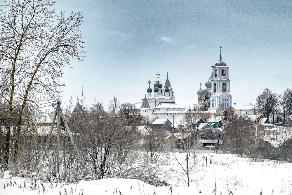 a snowy landscape with a church in the background