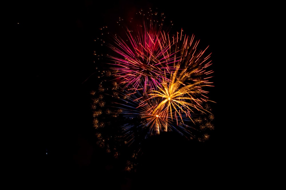 a colorful fireworks is lit up in the night sky