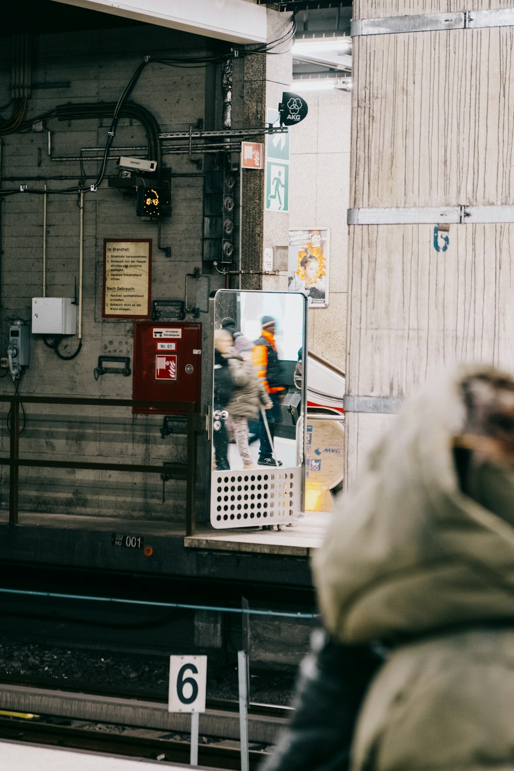 a man standing next to a train on a train track