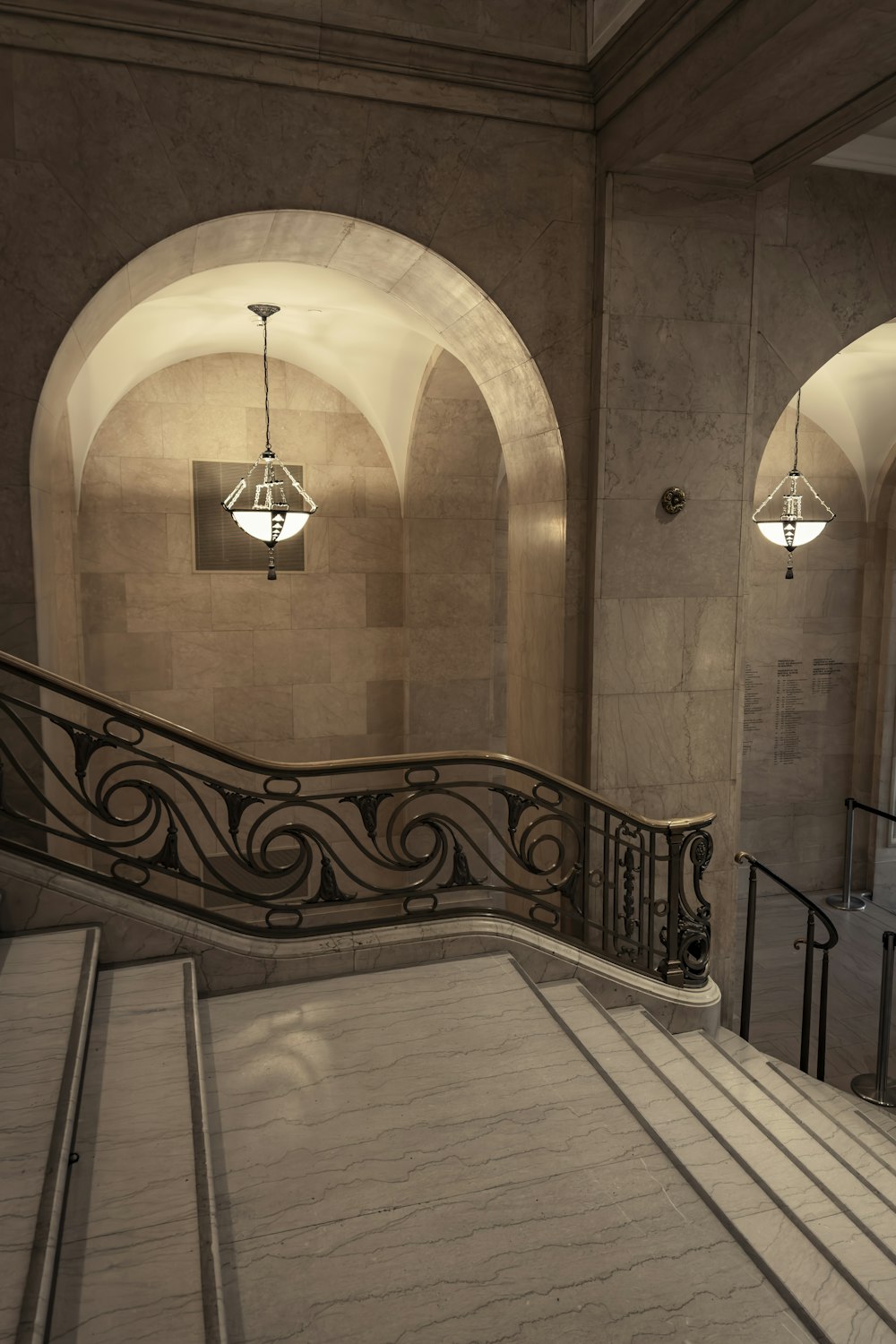 a staircase in a building with a clock on the wall