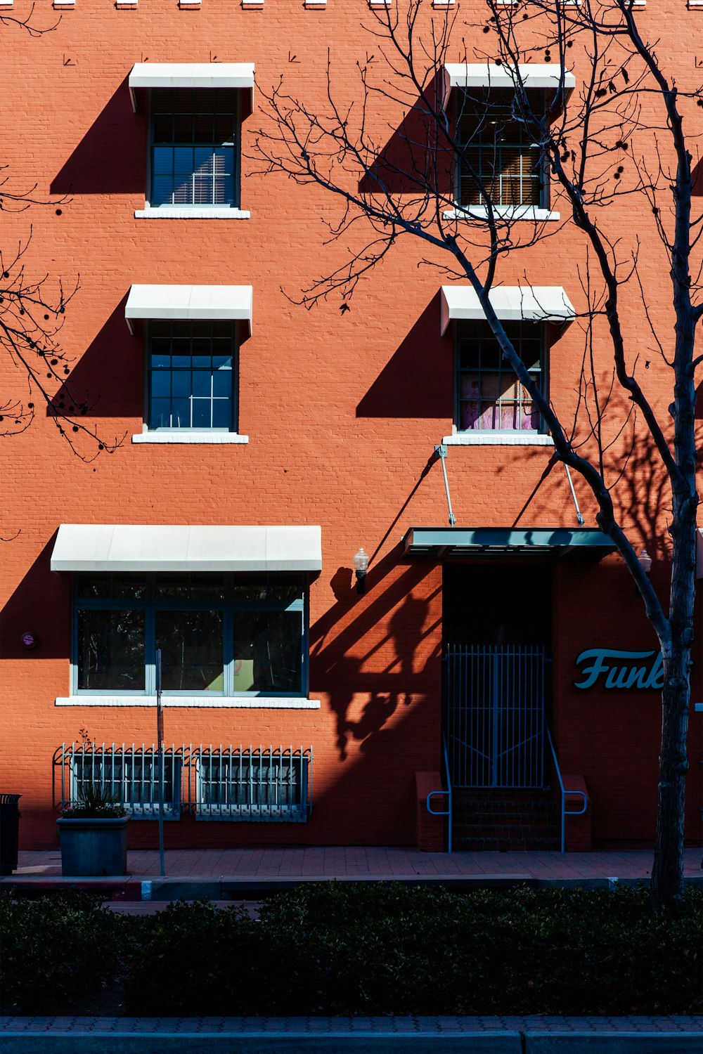 a tall red building with a clock on the front of it