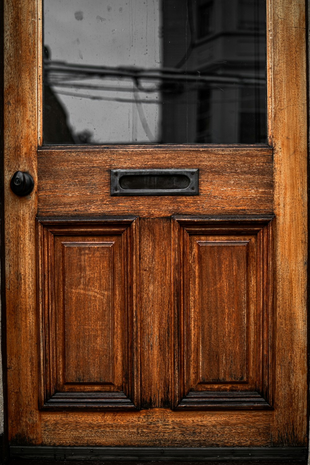 a close up of a wooden door with a glass