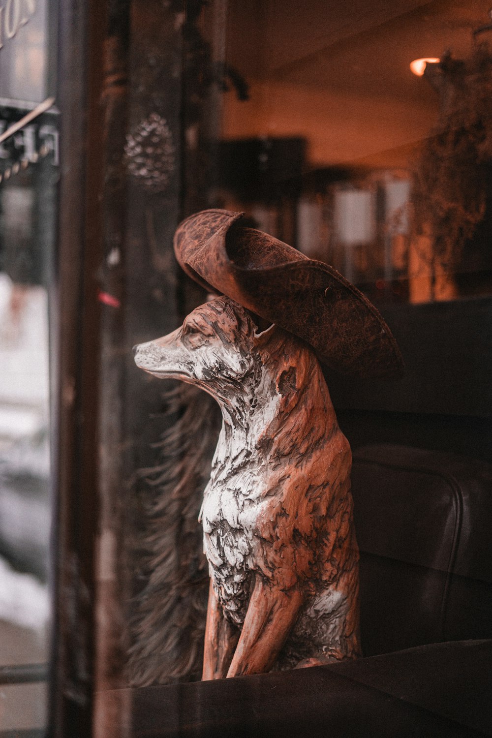 a statue of a dog wearing a hat