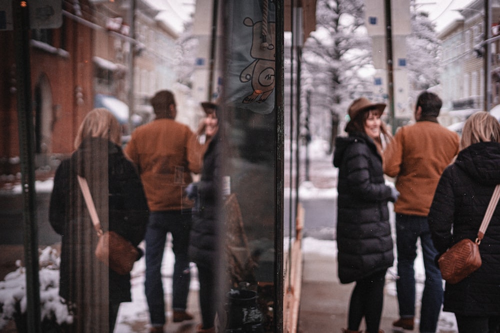 a group of people standing outside of a store