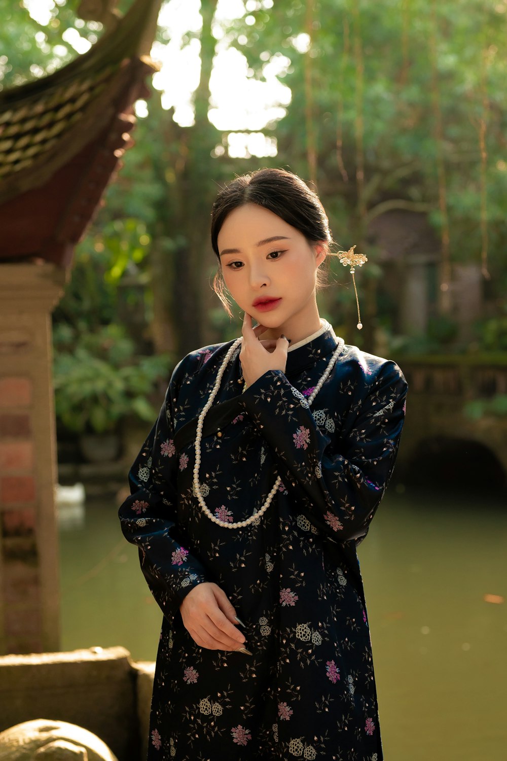 a woman standing in front of a body of water