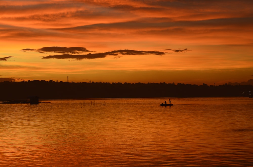 a couple of boats floating on top of a lake