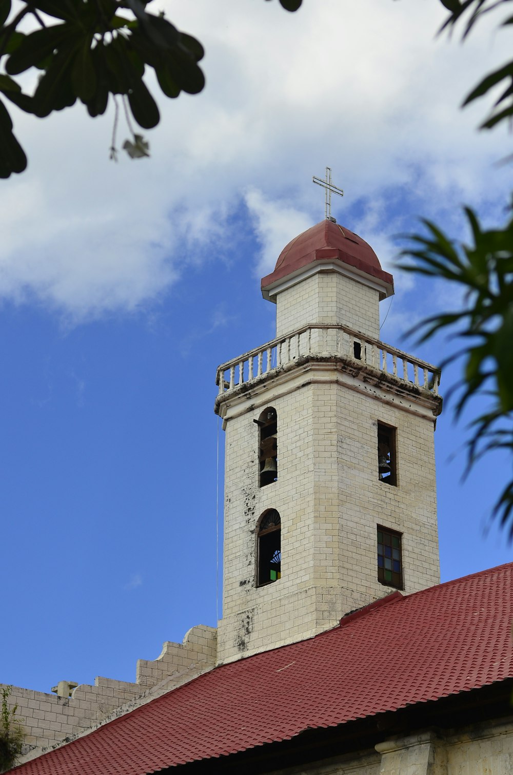 a tall tower with a cross on top of it