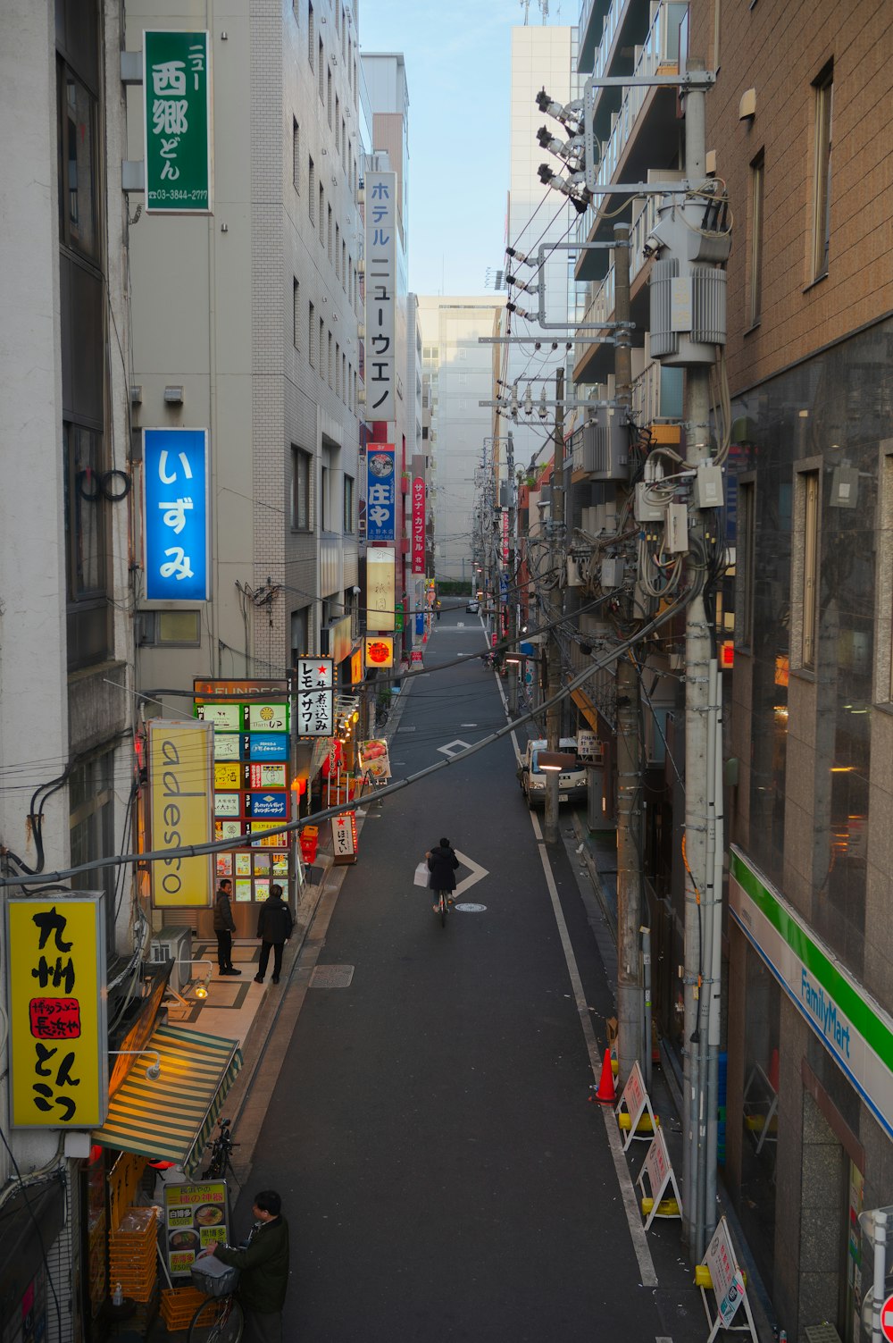 a narrow city street lined with tall buildings