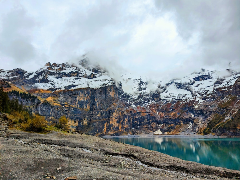 a mountain range with a body of water in the foreground