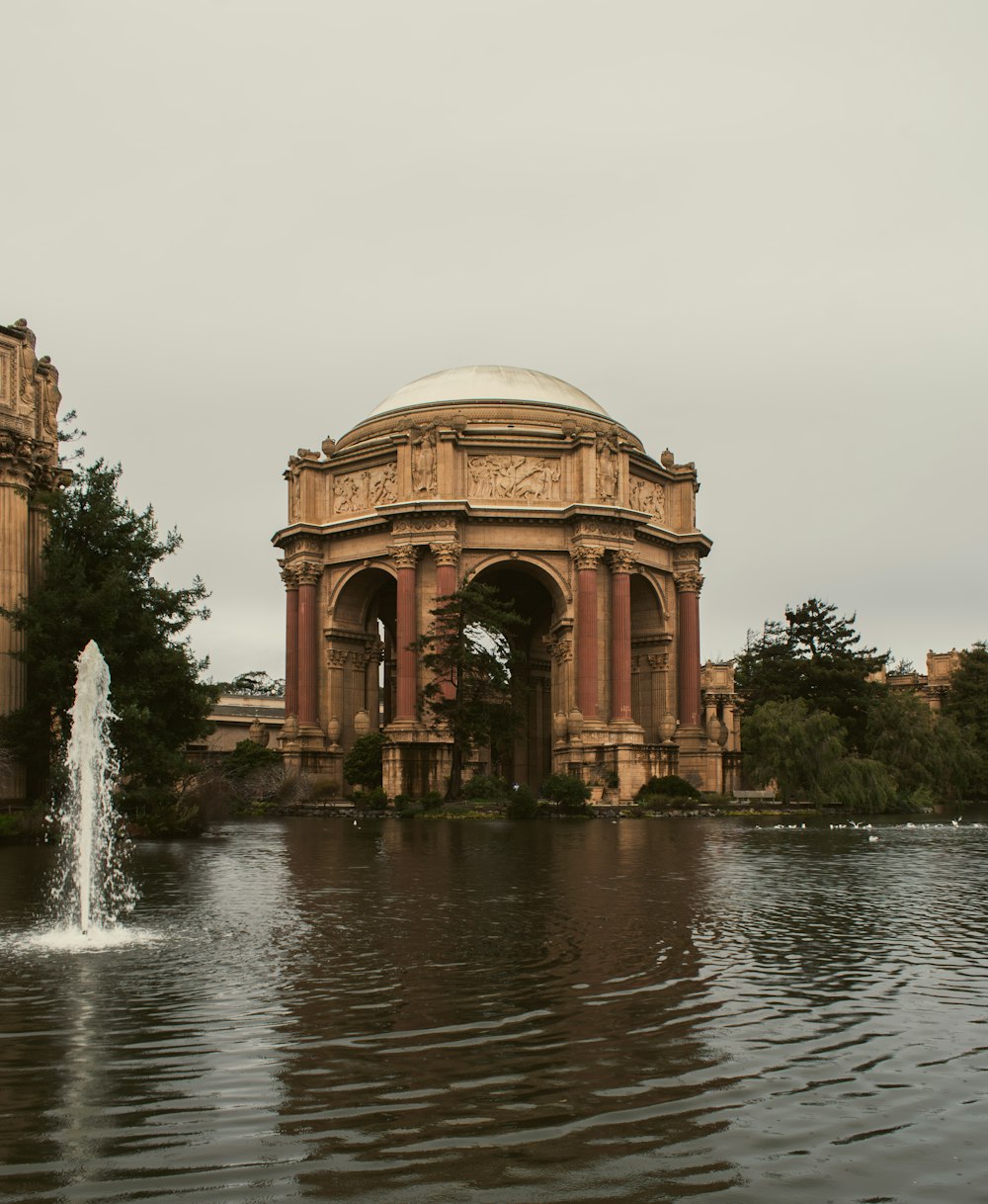 a large building with a fountain in front of it