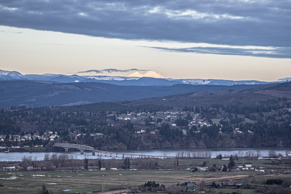 a scenic view of a town and mountains