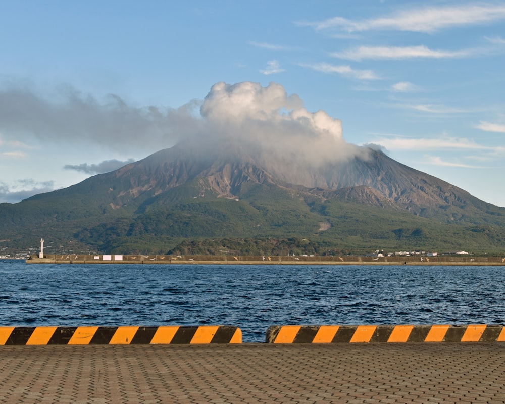 a large mountain with a cloud in the sky