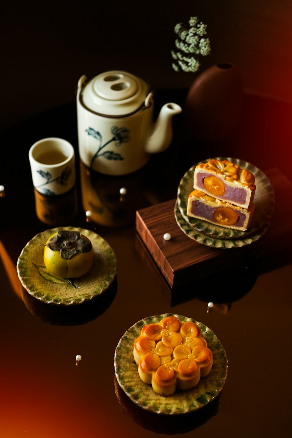 a table topped with plates of food and a tea pot