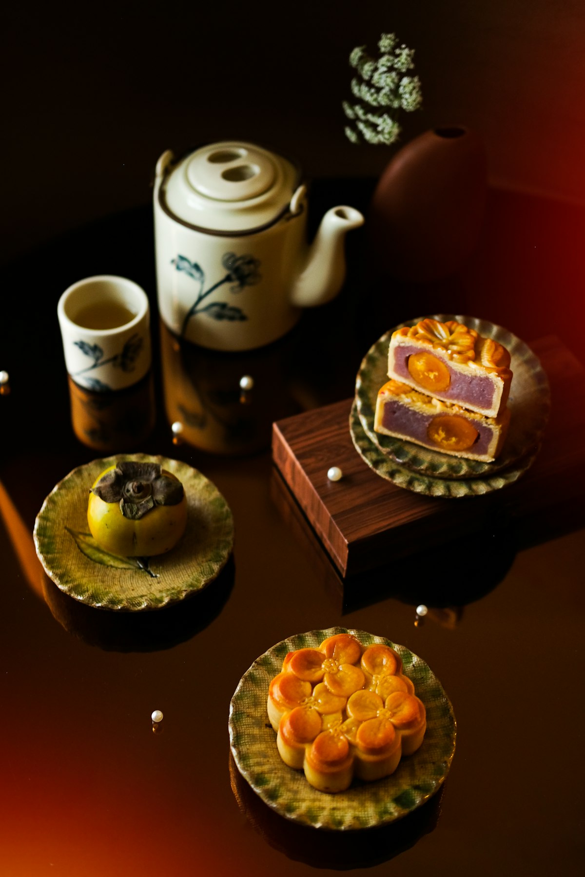 Traditional Chinese mooncakes with tea on a wooden table