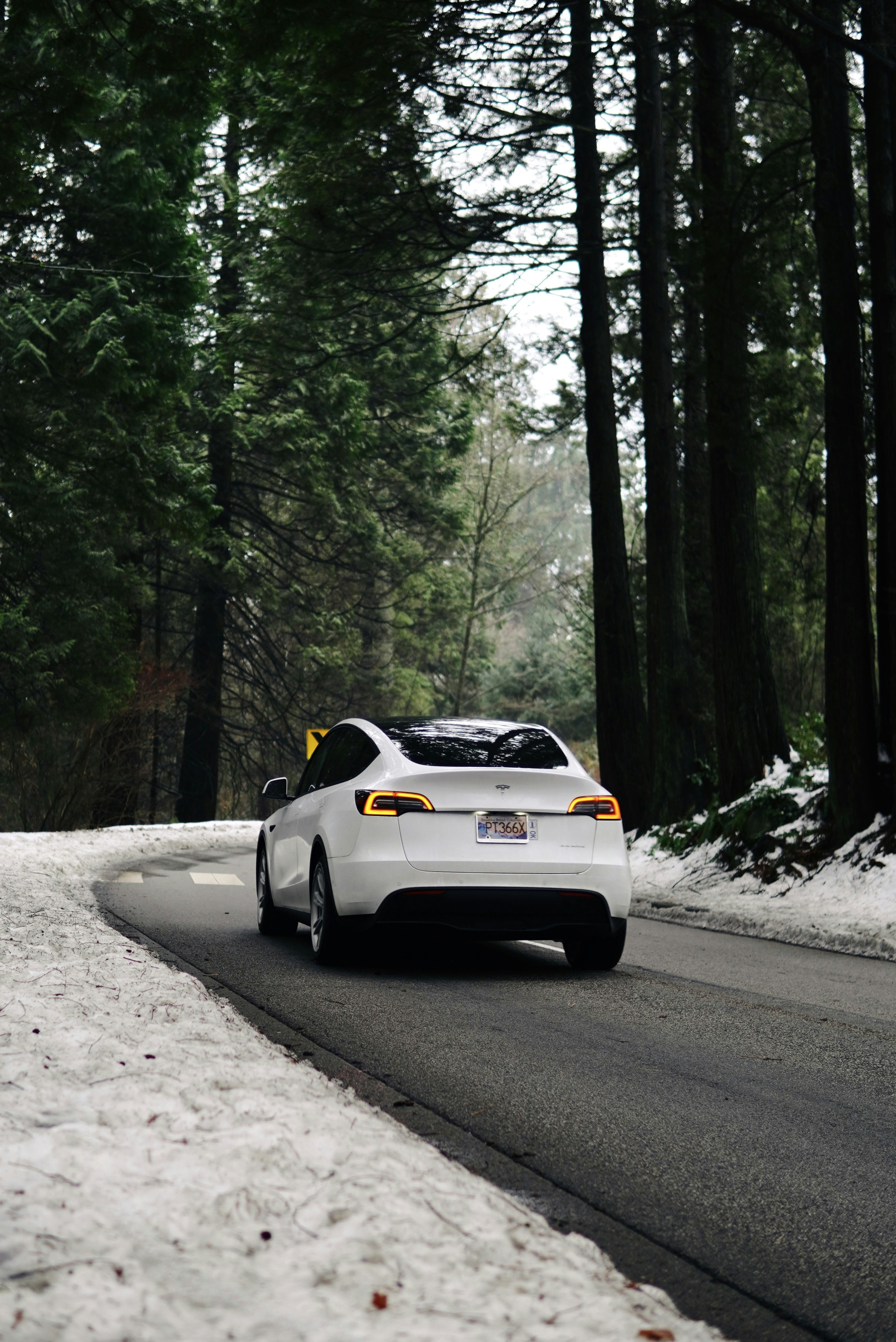 A white car driving down a snow covered road photo – Free Bc Image on ...