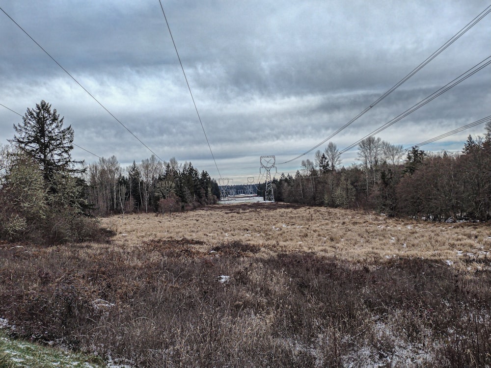 an empty field with power lines above it