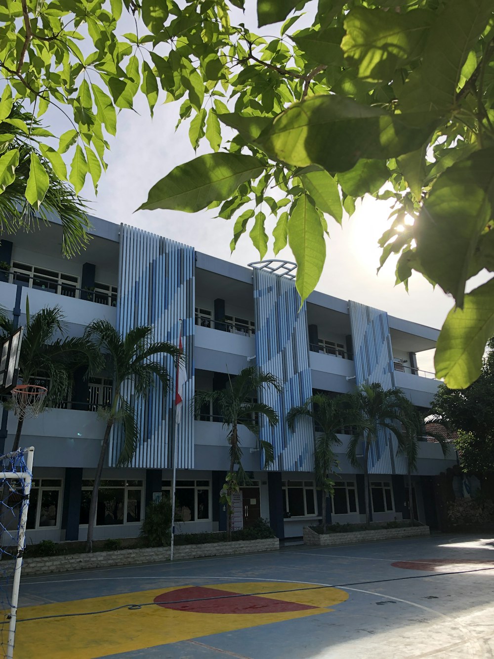 a building with a basketball court in front of it