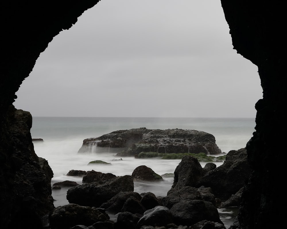 a view of a body of water through a cave