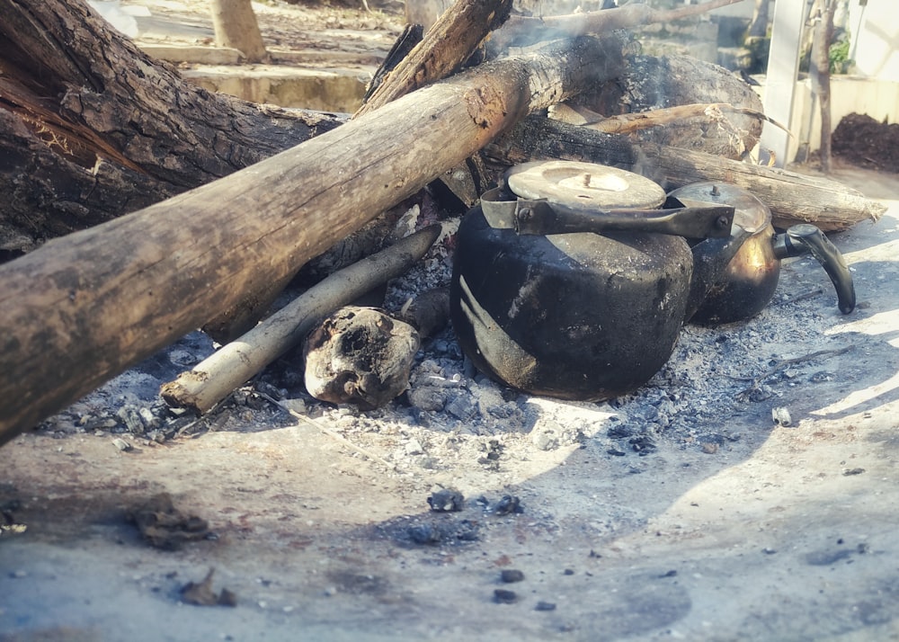 a pile of wood sitting on top of a fire pit