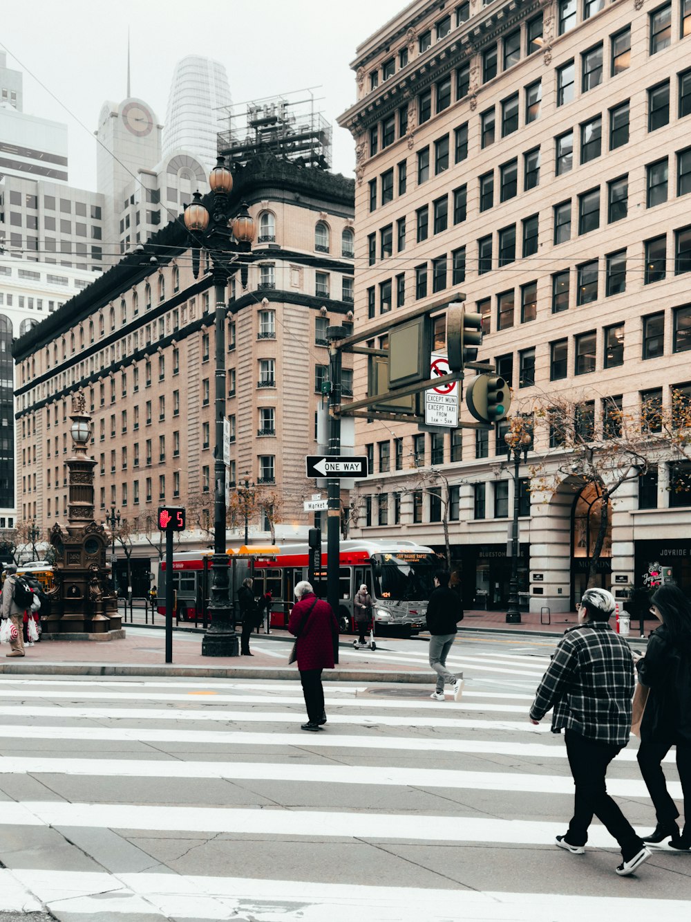 a group of people walking across a cross walk