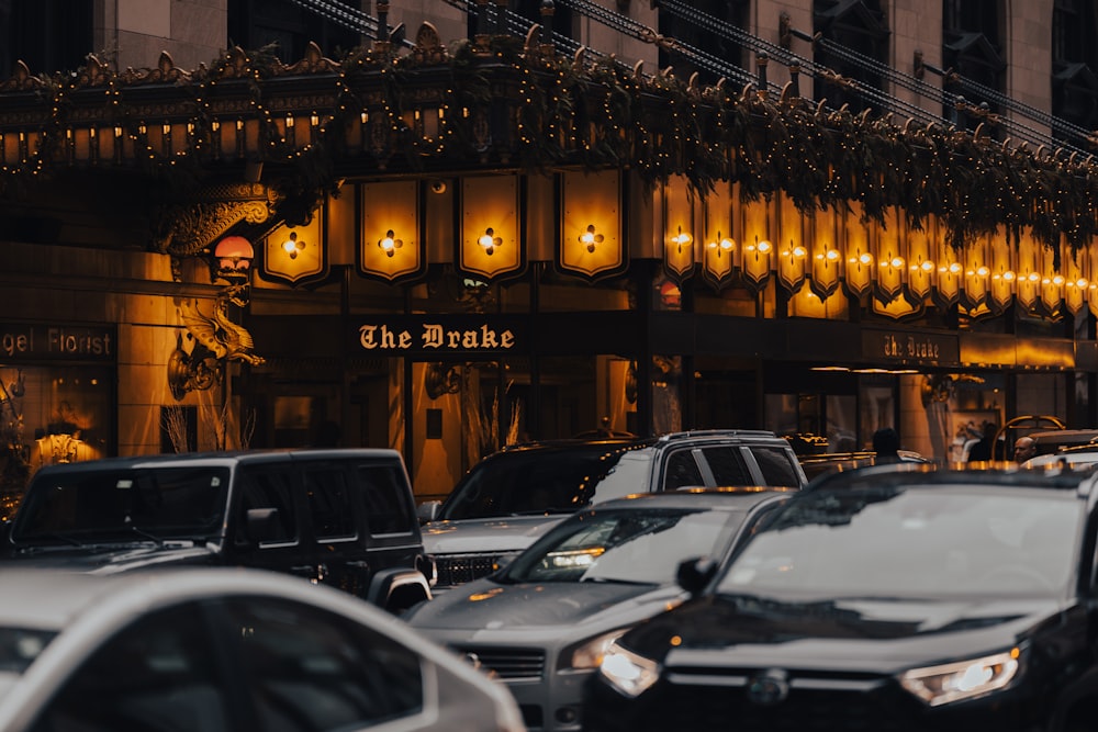 a street filled with lots of traffic next to a tall building