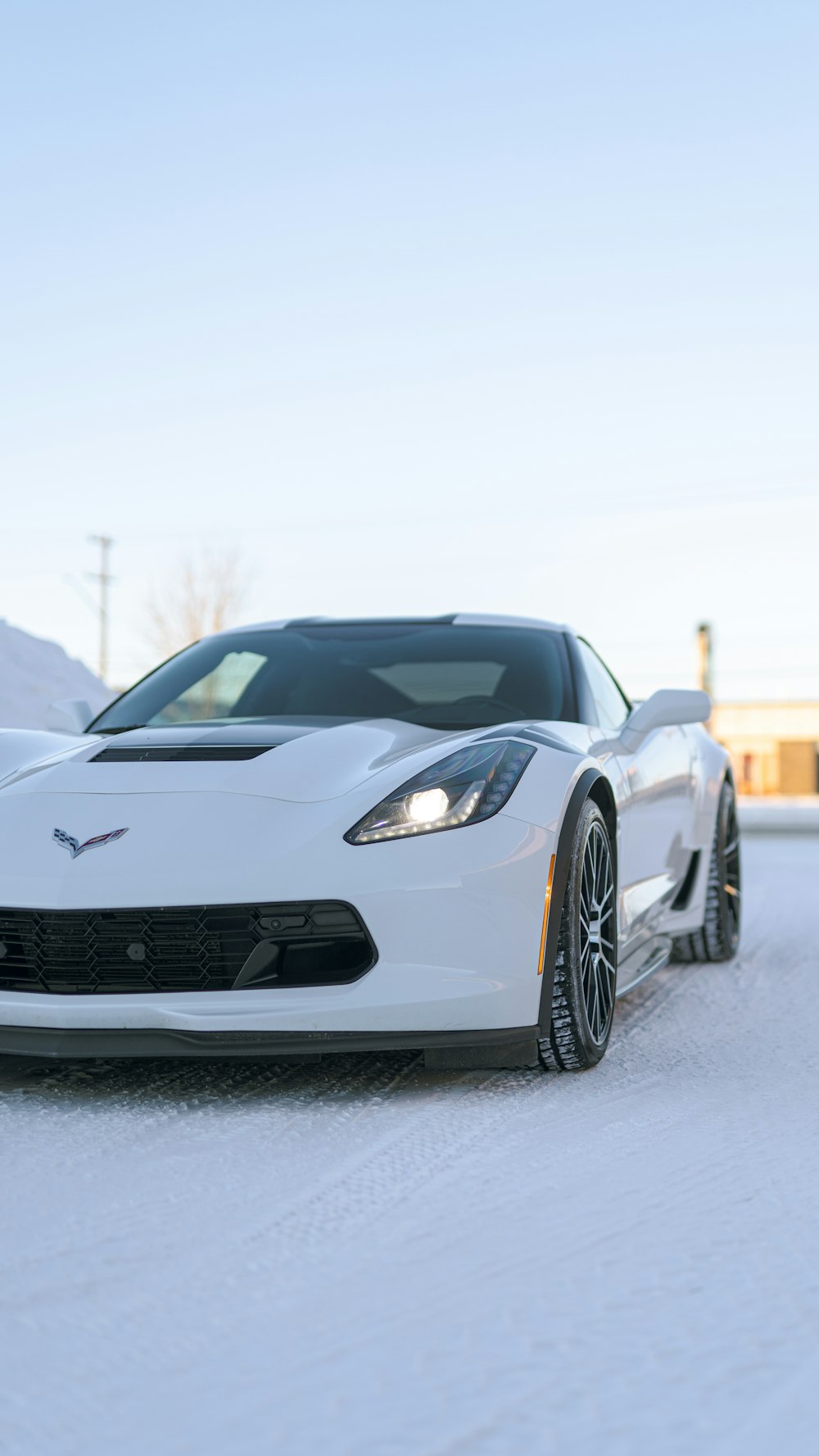 a white sports car parked in the snow