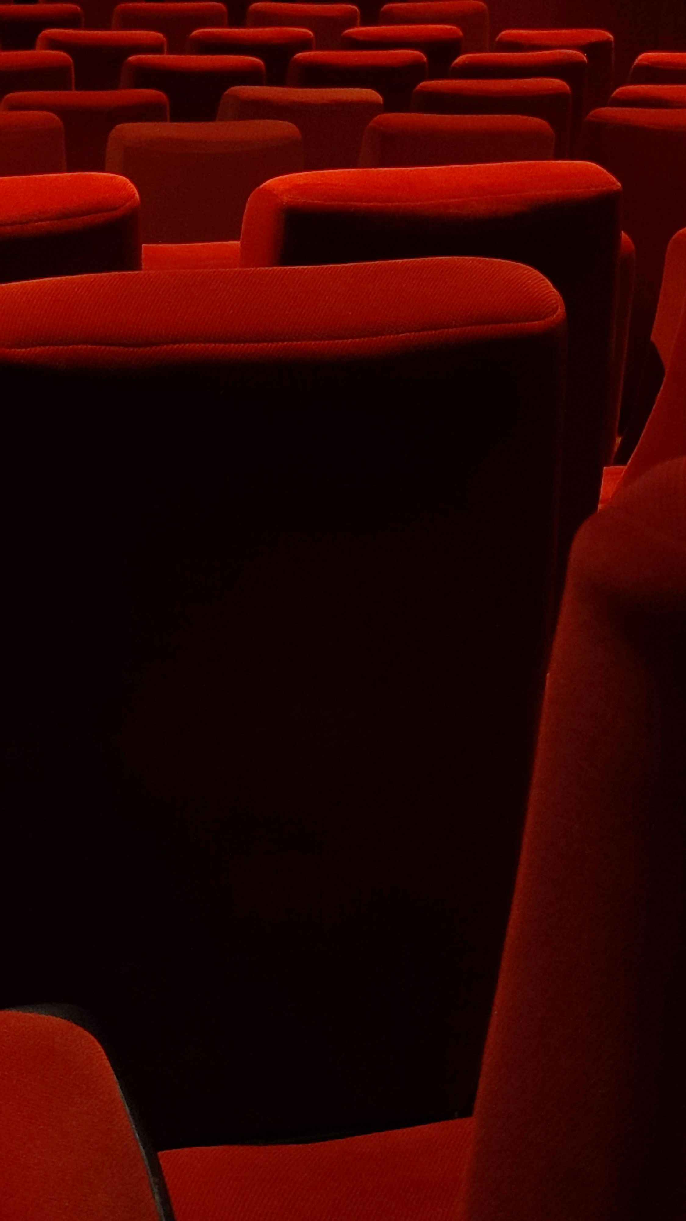 a row of red seats in a theater