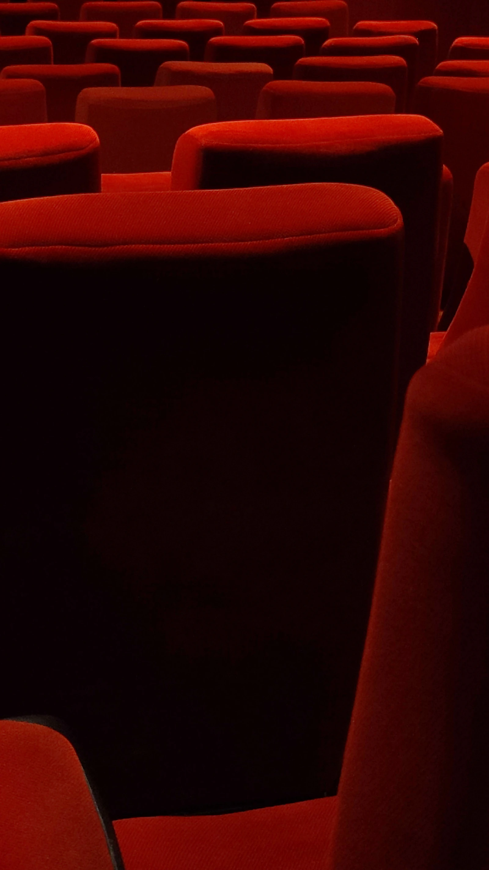 A row of red velvet seats inside the heritage hall