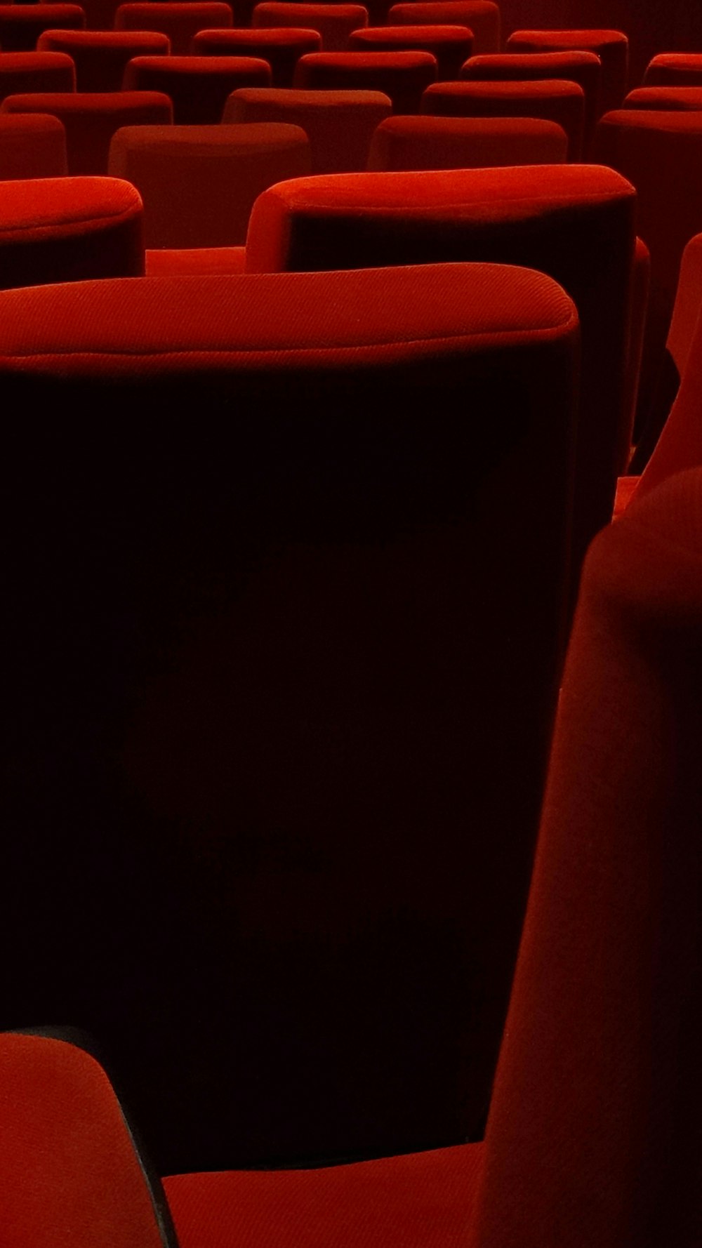 a row of red seats in a theater