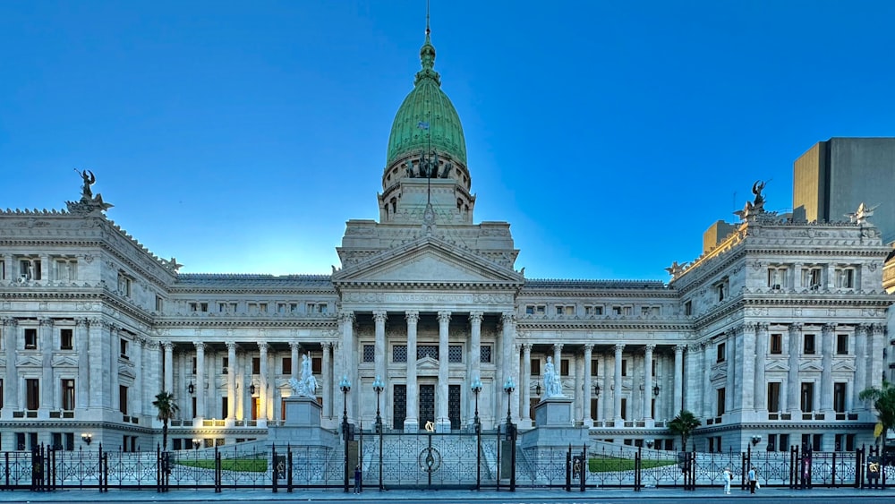 a large white building with a green dome