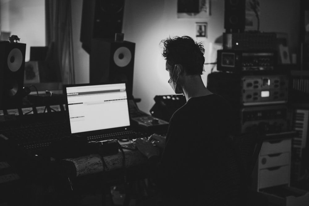 a person sitting in front of a laptop computer