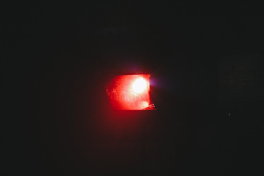 a close up of a red light in the dark