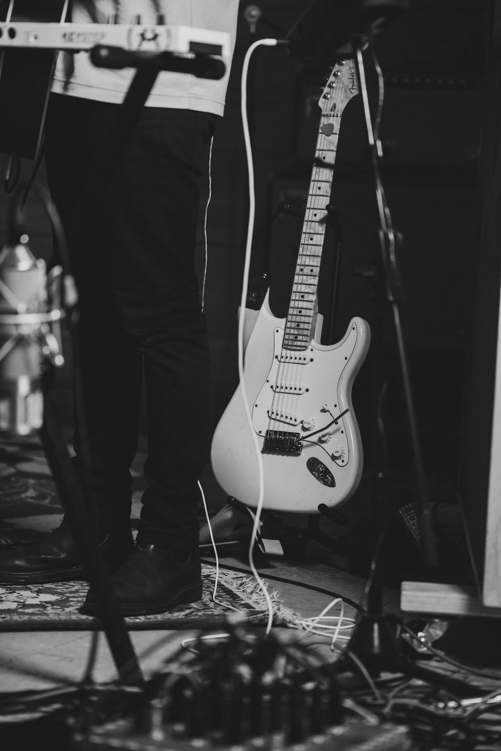 a black and white photo of a person playing a guitar