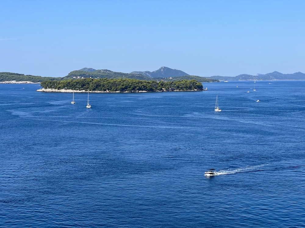 a group of boats floating on top of a large body of water