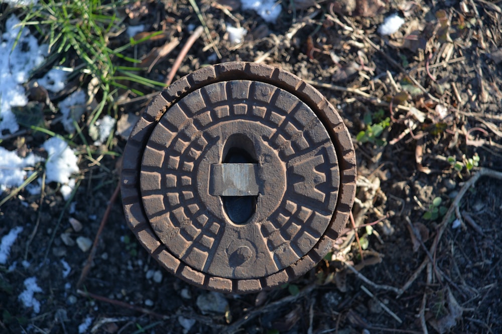an old manhole cover sitting on the ground
