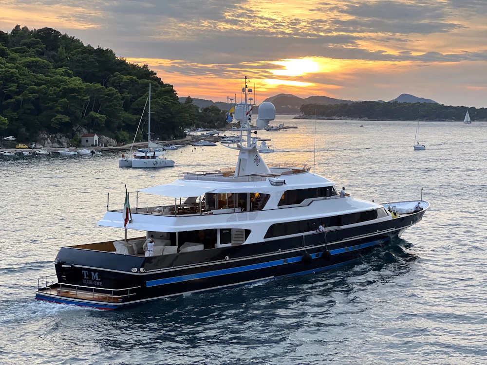 A yacht at sea at sunset