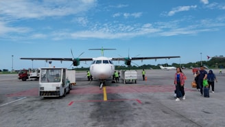 a group of people walking towards an airplane