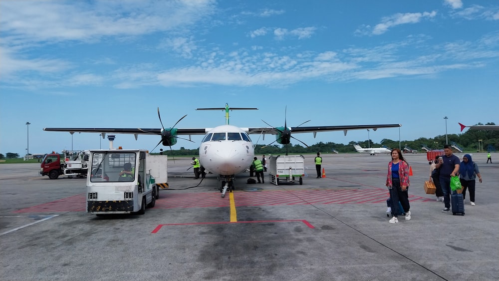 a group of people walking towards an airplane