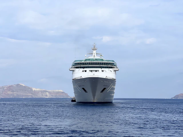 A cruise ship sailing across calm blue sea
