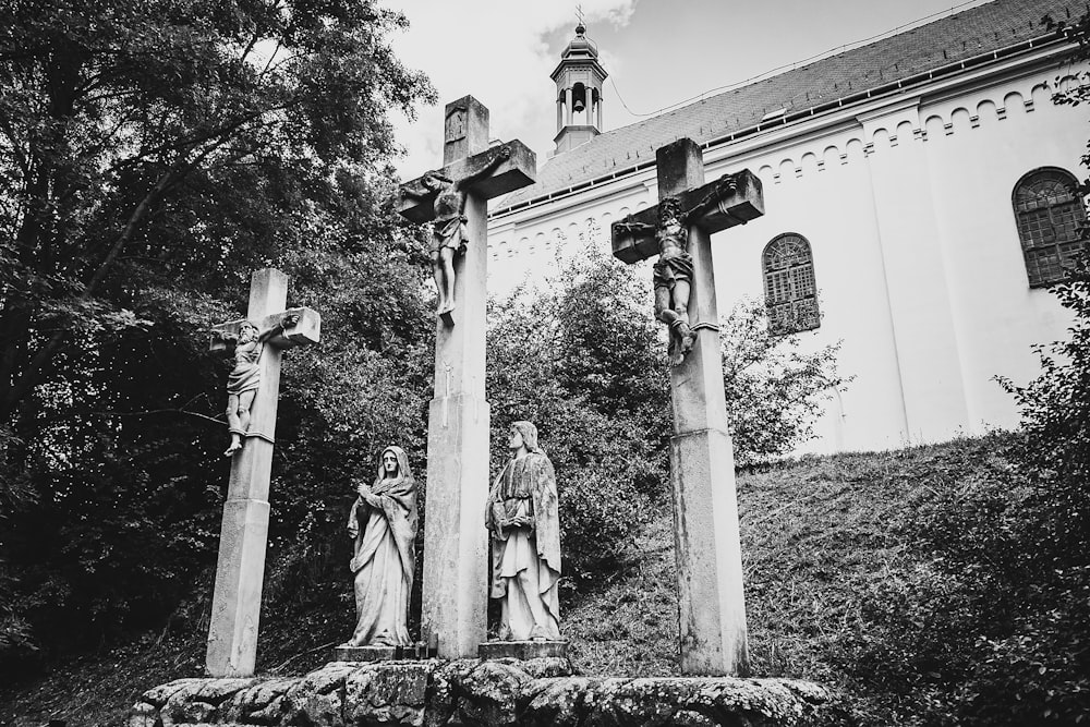 a black and white photo of statues in front of a building